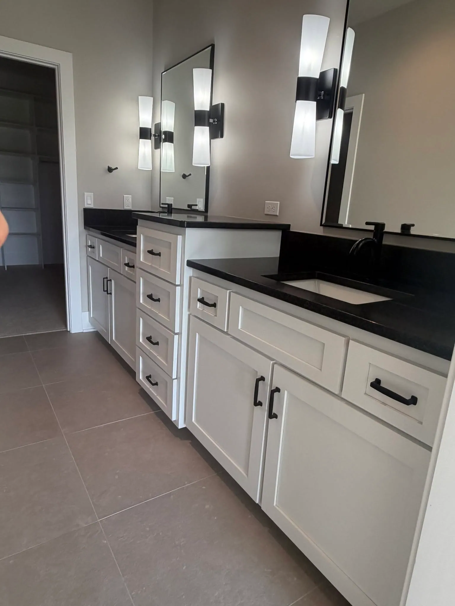 Double vanity with black stone counters