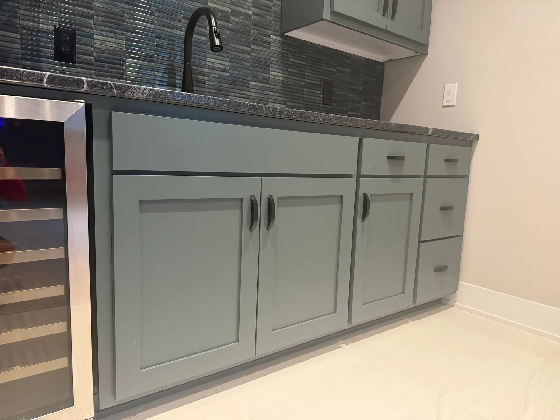 Beverage bar with green cabinetry and a wine fridge