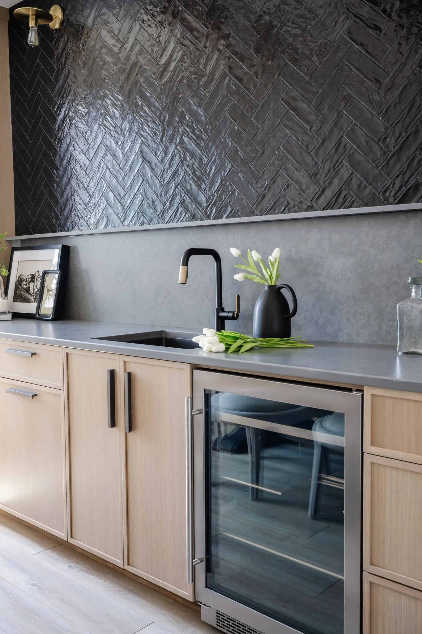 Wet bar with herringbone tile and a wine fridge