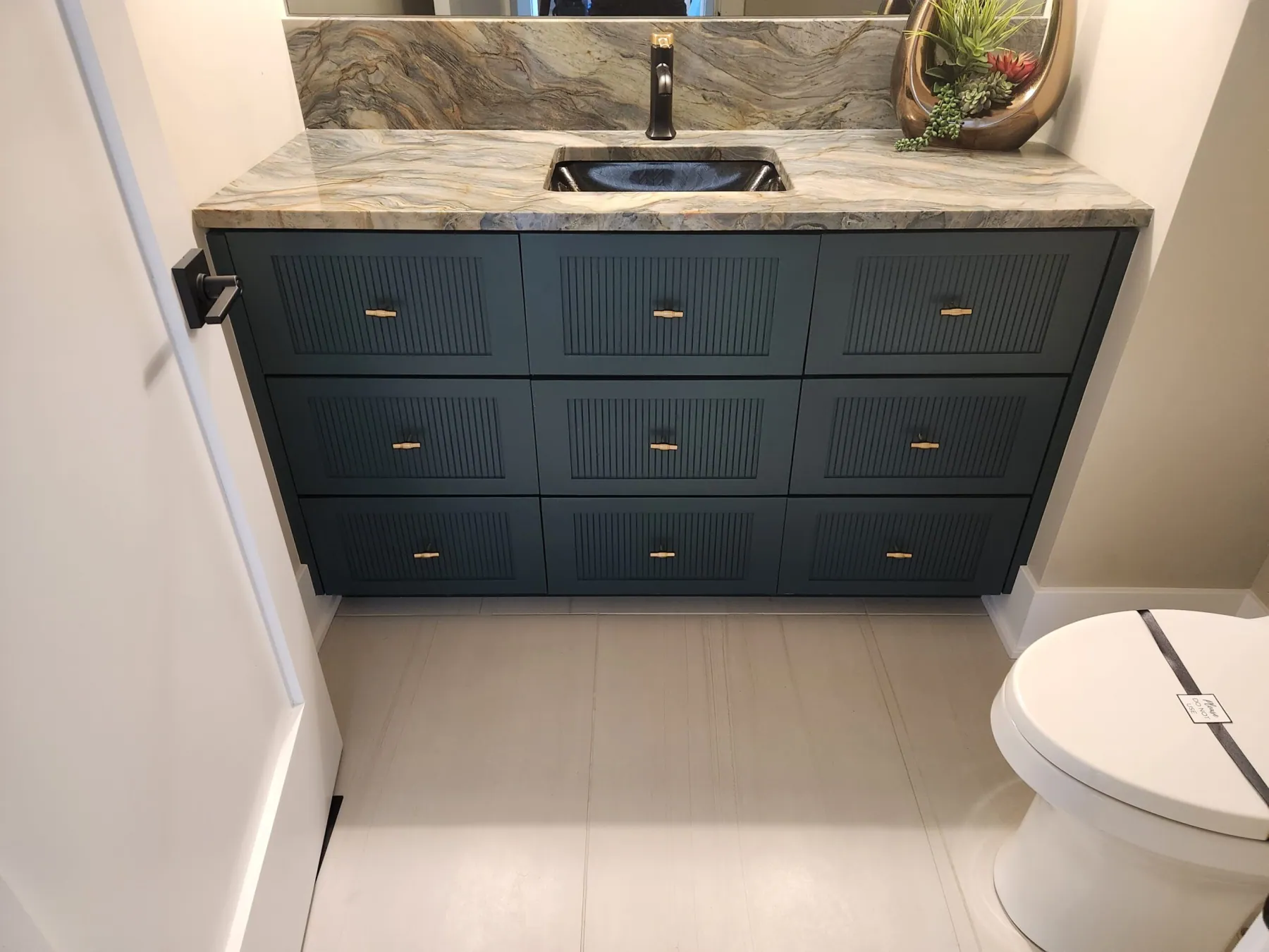Custom deep-teal fluted bathroom vanity by Fox Custom Cabinets
