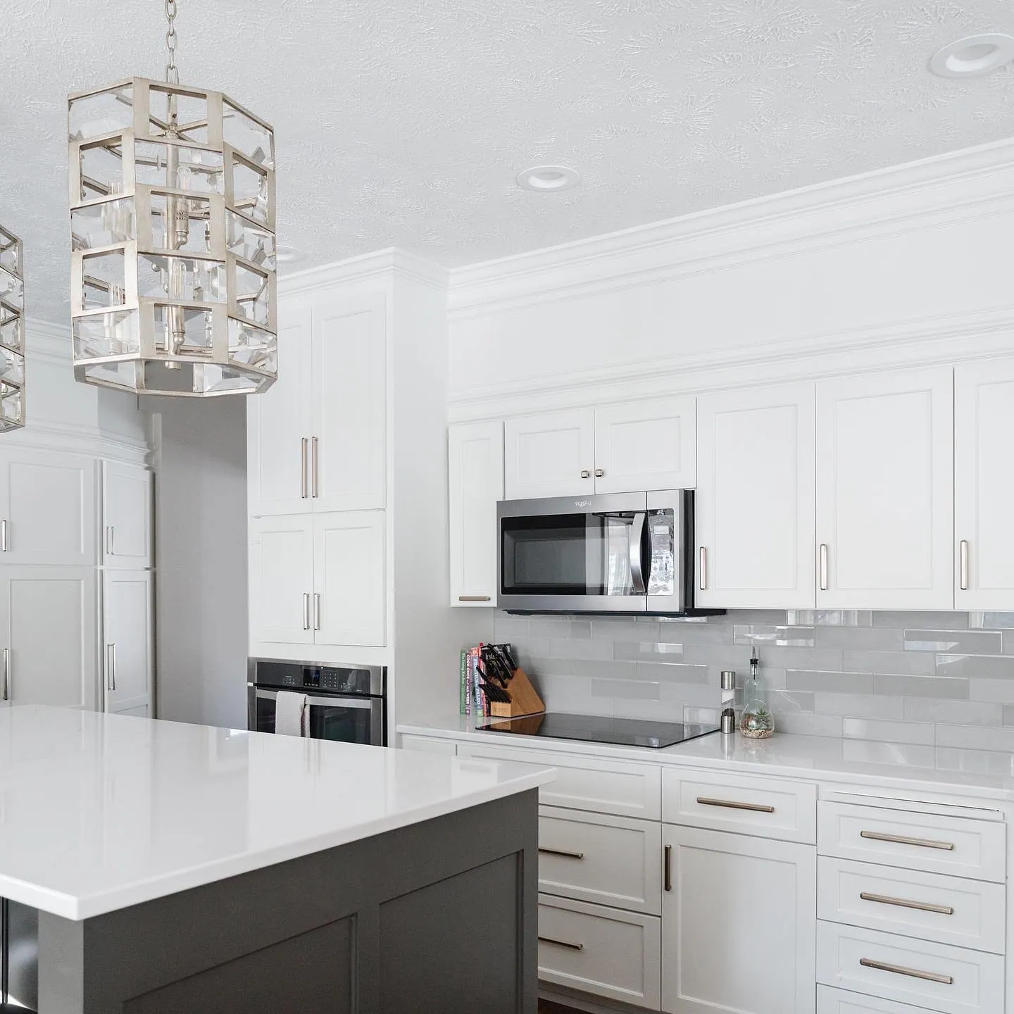 White shaker kitchen with a farmhouse sink and quartz counters